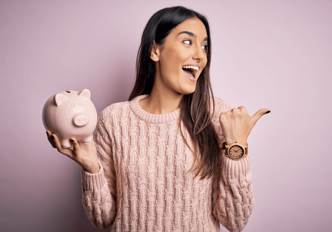 Woman holding piggy bank saving money.